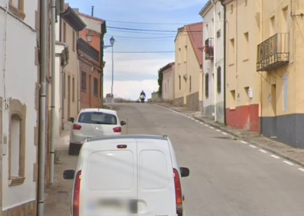 Un homme poussant un grand paquet blanc dans une brouette