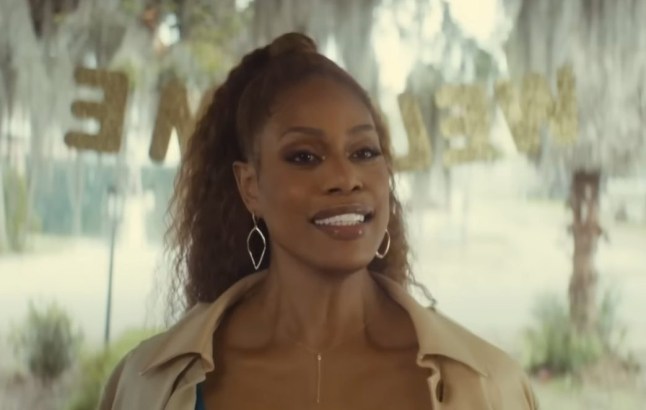 Laverne Cox as Desiree smiling at a welcome home party in Clean Slate
