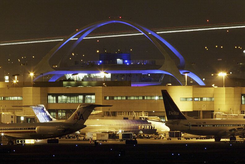 photo of three parked airplanes, at an airport. one plane belonging to American Airlines, another Spirit Airlines, and the other being Delta Airlines.