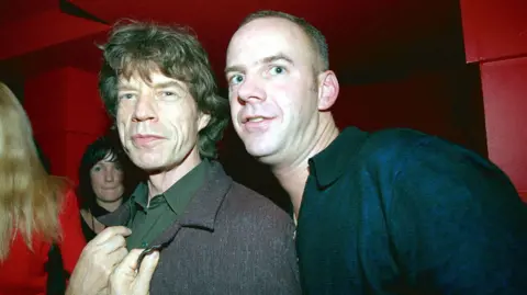 Norman Cook et Mick Jagger lors d'une after-party de David Bowie à Londres, 1999