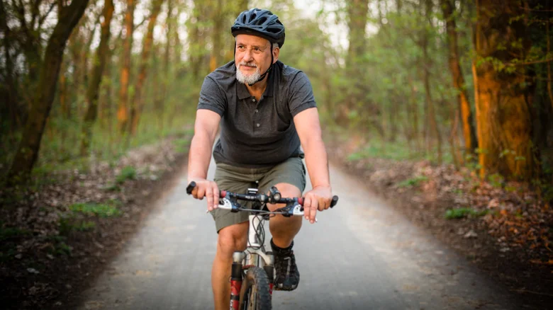 Homme faisant du vélo en extérieur.