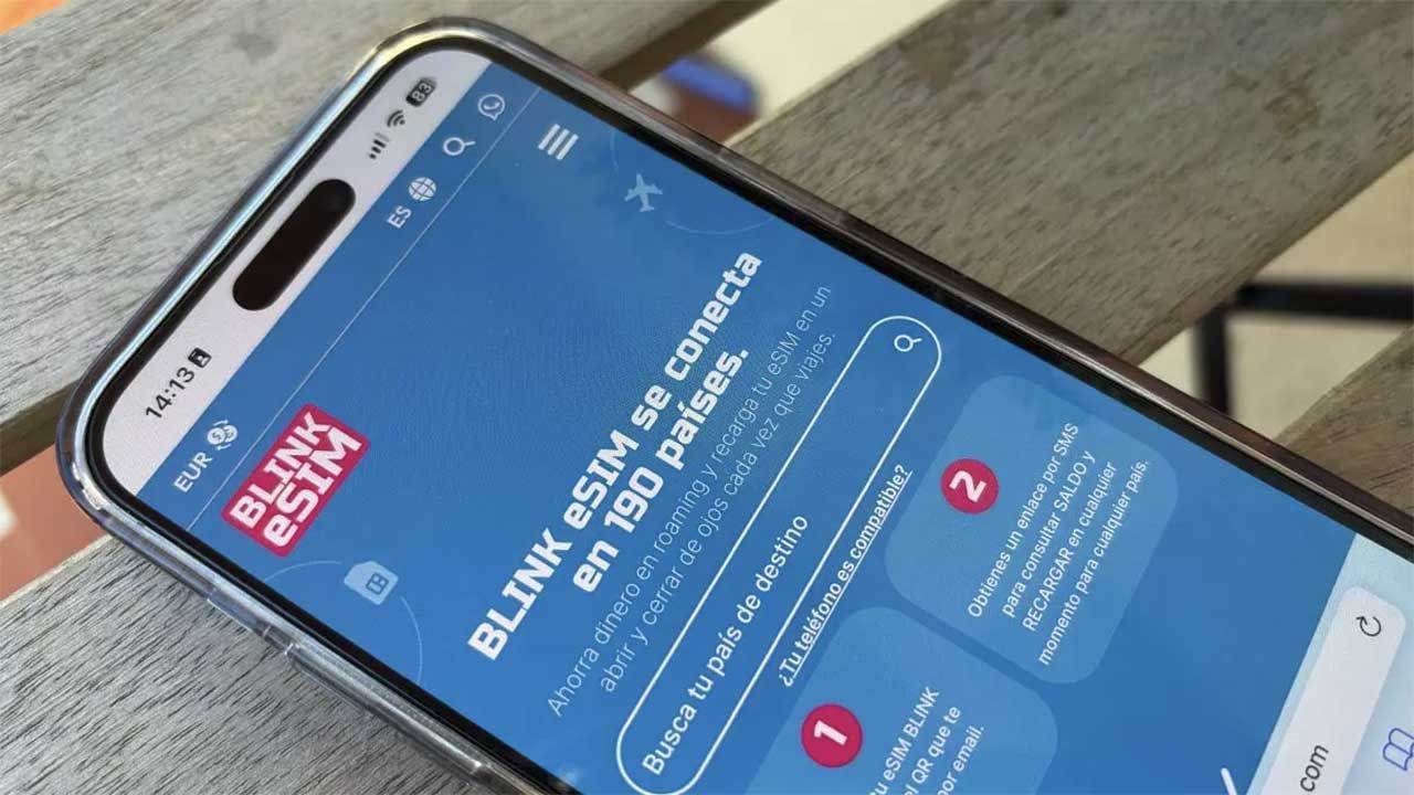 Un smartphone affichant la page web de Blink eSIM sur une table en bois.