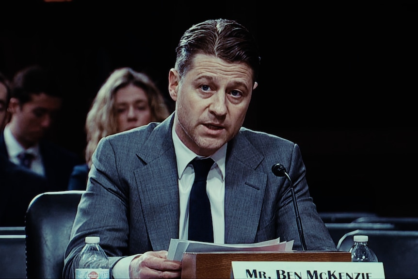 Ben McKenzie with a nameplate in front of him.
