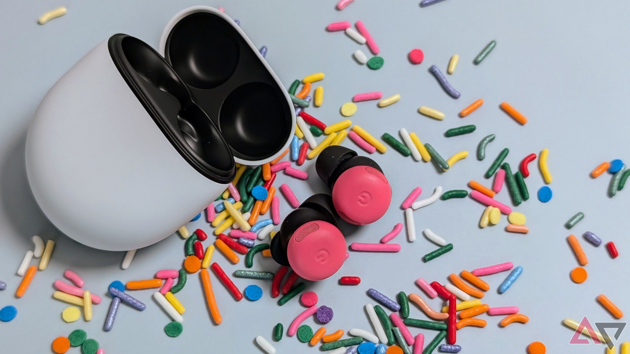 Google Pixel Buds Pro 2 case with peony buds on table surround by sprinkles