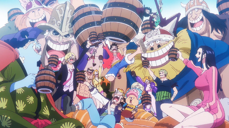L'équipage au chapeau de paille célébrant avec des géants après une victoire dans One Piece