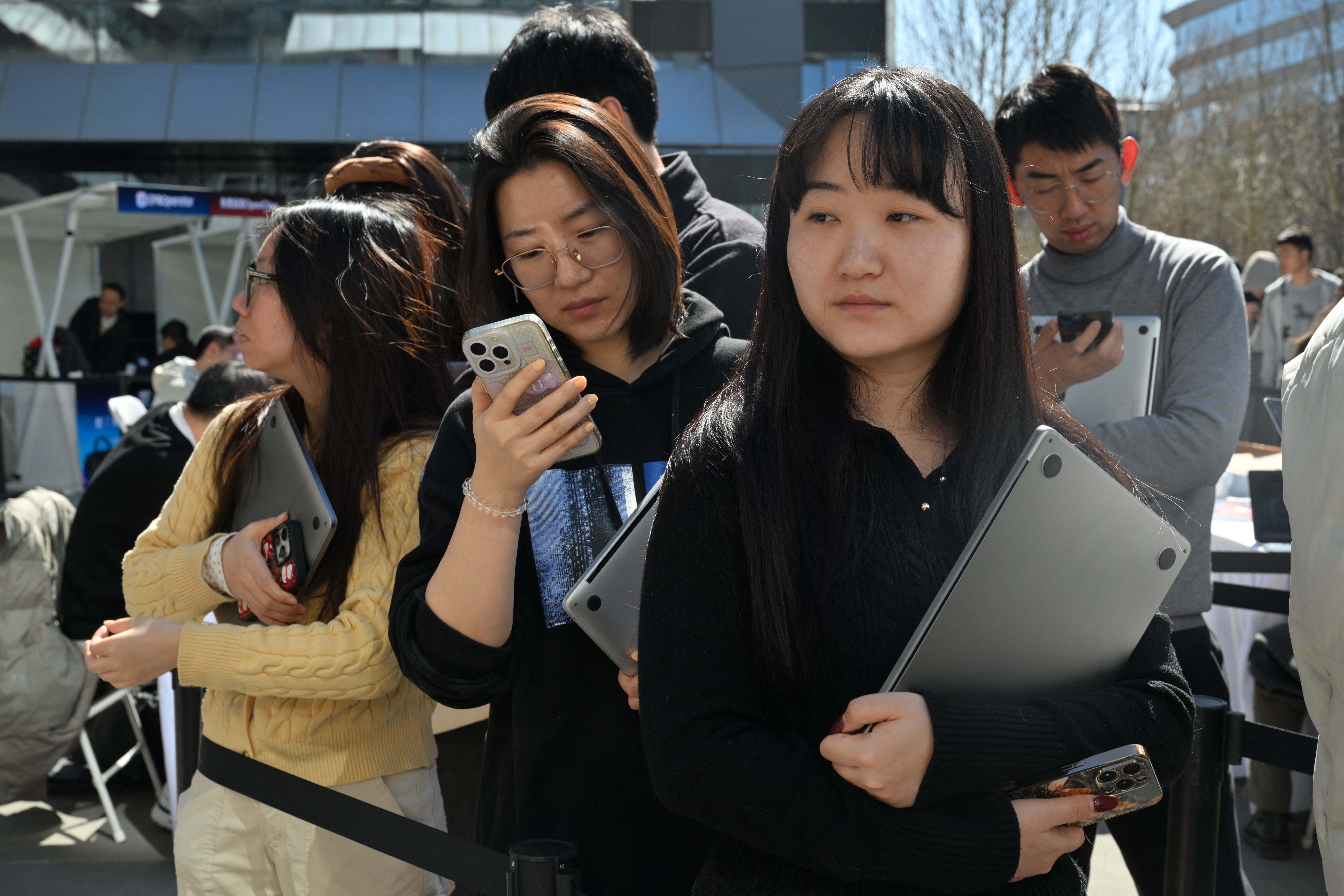 Des personnes font la queue pour faire installer OpenClaw sur leurs ordinateurs portables au siège de Baidu à Pékin.